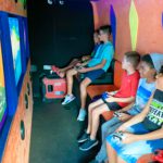 Kids playing video games in the Arcade Truck