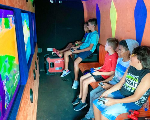 Kids playing video games in the Arcade Truck