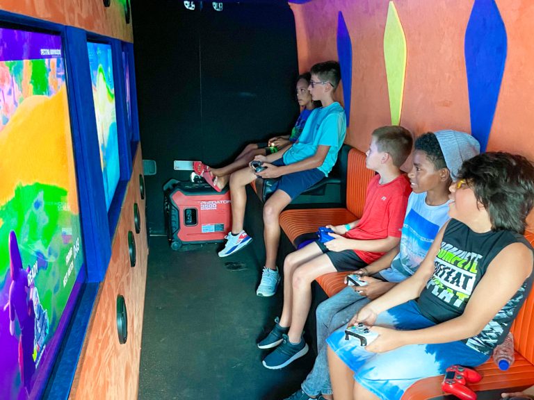 Kids playing video games in the Arcade Truck